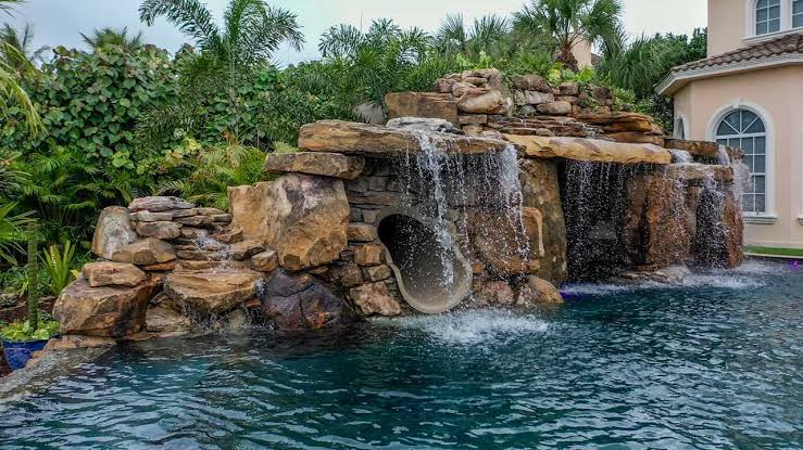 Resort-style backyard pool with water features — Spring Hill FL