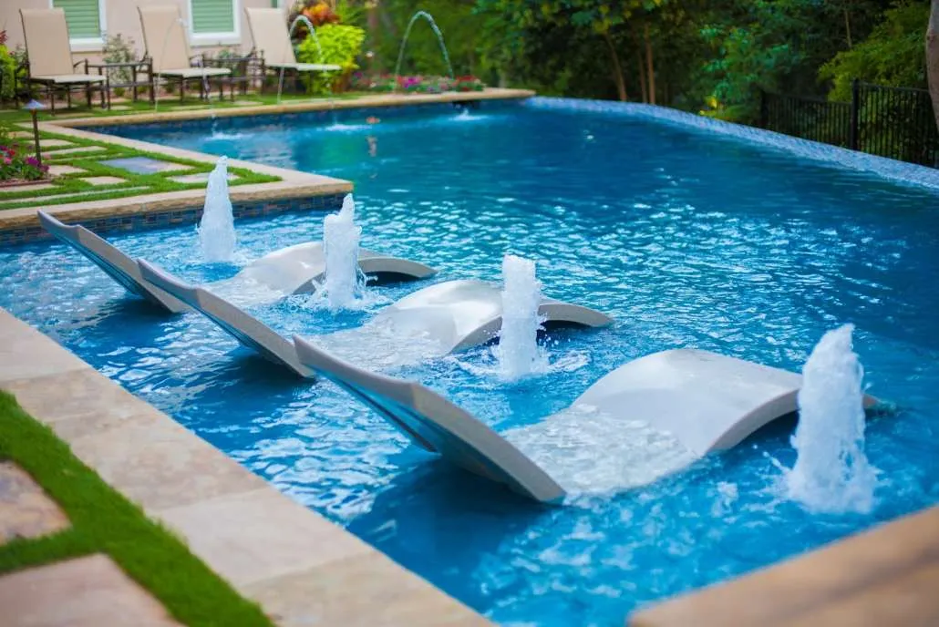 Elegant water fountain feature near a luxury pool